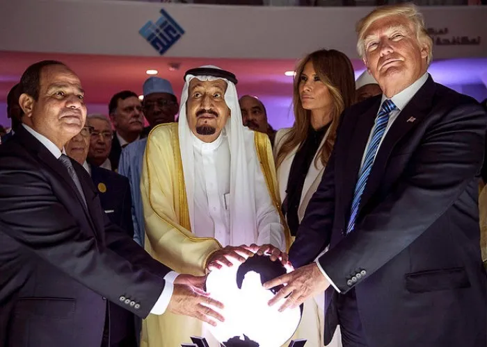 Press photograph of King Salman, President Trump, and President el-Sisi with hands on a glowing globe at the Global Center for Combating Extremist Ideology, Riyadh